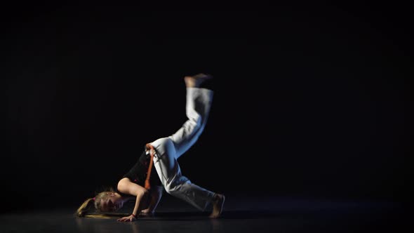 Strong Woman Performing Incredibly Complex of Martial Art of Capoeira