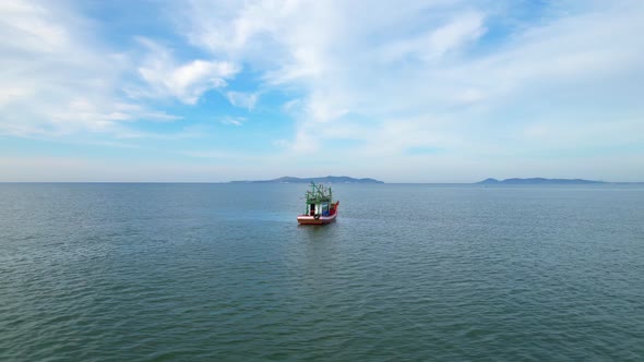 A fisherman is sailing in the sea among the islands near the coast.