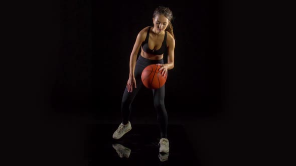 Athletic woman playing basketball