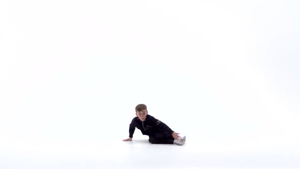 Little Boy Is Dancing a Modern Dance on the White Background in Black Leather Jackets and Jeans