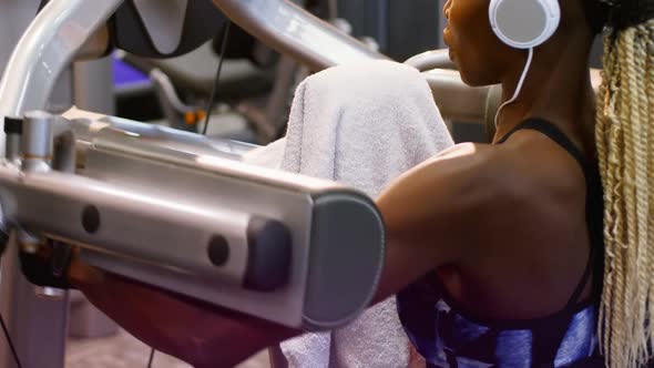 Fit woman exercising on a machine