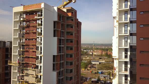 Aerial view of high residential apartment buildings under construction. Real estate development.