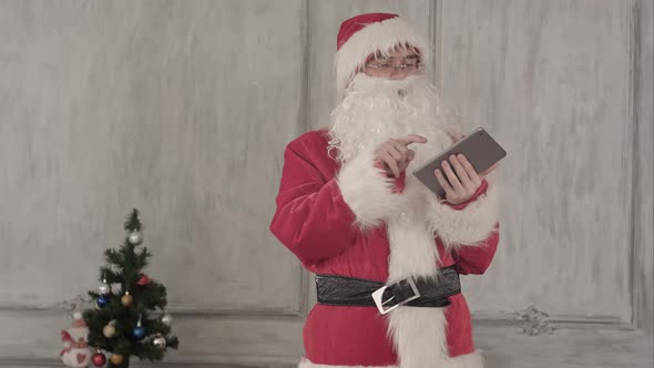 Santa Claus Using Tablet Computer on White Background