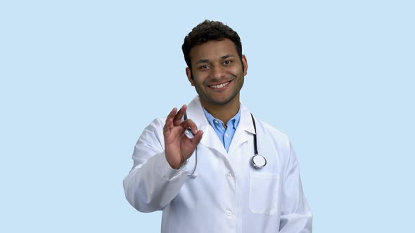 Cheerful Doctor with Stethoscope Showing Ok Sign