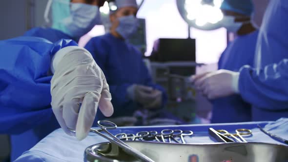 Multi-ethnic surgeons performing surgery in operation room at hospital