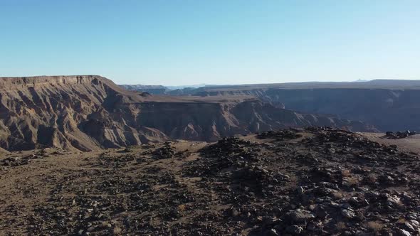 Stunning aerial footage of the huge canyon with tall cliffs and rocky hills