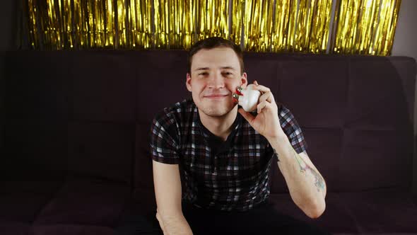 Young Happy Man Using 3d Massager for Face