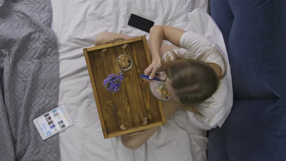 Woman Eating Healthy Breakfast in Bed