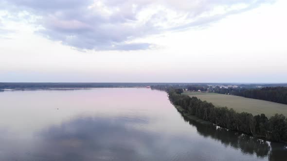 A Beautiful Panorama of a Large Lake Taken From a Bird's Eye View on a Summer Day and a Cottage