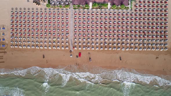 Aerial view of amazing beach with colorful umbrellas