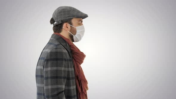 Gentleman Wearing a Protective Face Mask Walking on Gradient Background.