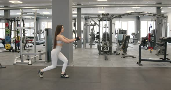 Side View of Attractive Girl with Long Dark Hair Performs Lunges