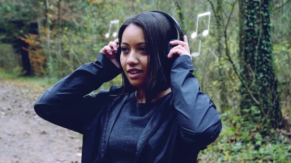 Young woman puts on headphones and immerses in a world of her own