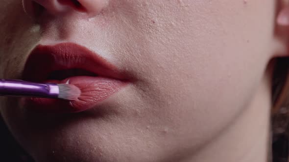 Makeup Artist Applies Lipstick to Lips