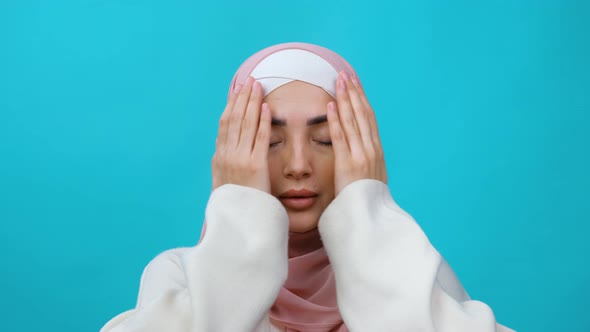 Young Muslim Woman in Hijab Raises Her Hand and Prays