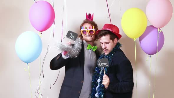 Friends having great time in party photo booth