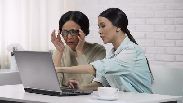 Young Woman Teaching Grandma to Use Computer App, Writing Email, Generation Gap