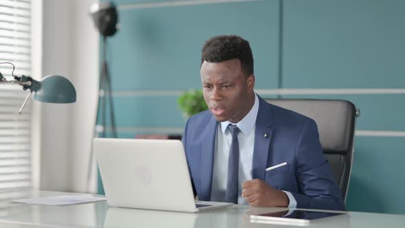 Angry African Man Fighting Arguing While Using Laptop