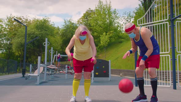 Active Senior Man Woman Playing Basketball on Sports Playground Court During Coronavirus Pandemic