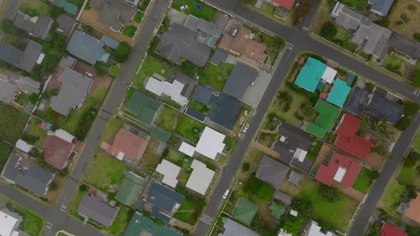 Top Down Panning Footage of Residential Area in Town and Family Houses with Colourful Roofs