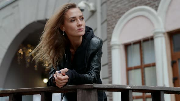 Beautiful Thoughtful Woman is Looking on City Street in Downtown Portrait