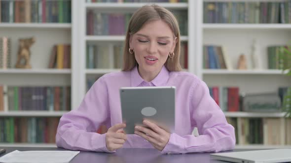 Woman Making Video Call on Tablet in Office