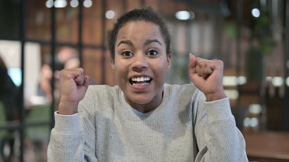 Excited African Woman Celebrating Success, Winning