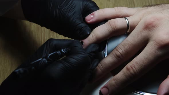 Manicure - Master Doing Chosen Design with a Black Nail Polish