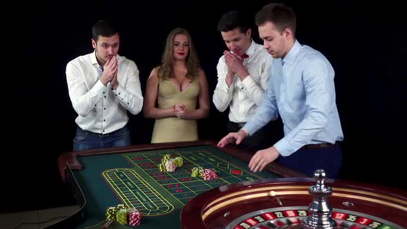 Young and Happy People Playing the Casino Roulette