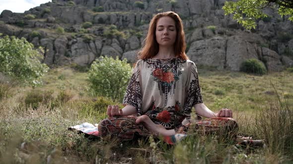 Beautiful and Healthy Ginger Woman Breathing Gently and Sits in Pose of Lotus