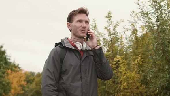 Caucasian Man Talking on Phone Outside