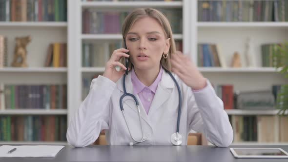 Lady Doctor Talking on Phone in Clinic