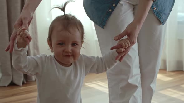 Woman Teaching Kid How to Walk alt
