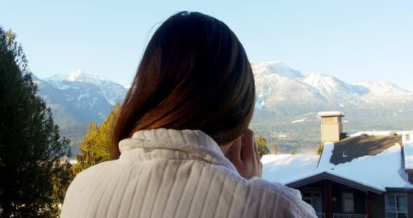 Woman having coffee in balcony