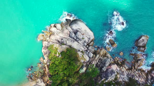 Wide fly over island view of a sandy white paradise beach and aqua turquoise water background 