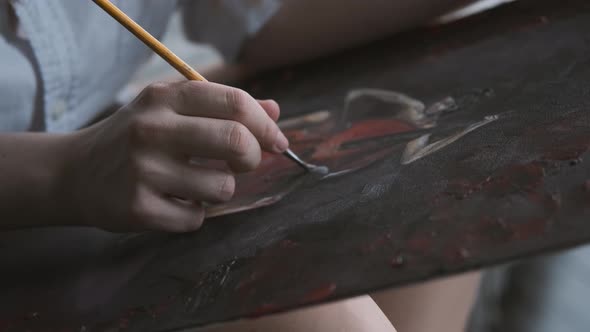 The Girl Artist Paints a Picture of Paints. Female Hands Closeup