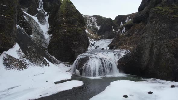 Aerial view of Stjornarfoss waterfall in wintertime in Iceland.