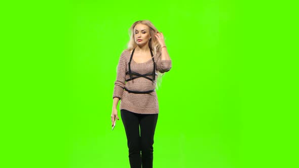 Girl with Long Curly Hair Talking on the Phone. Green Screen