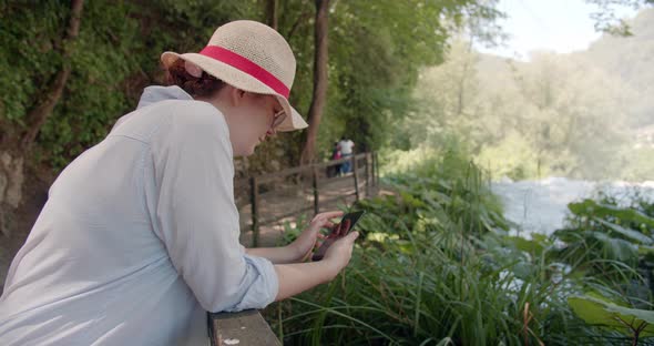 Caucasian female in a blue shirt Use Phone