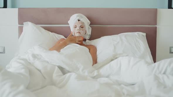 Woman with Paper Collagen Cosmetic Mask