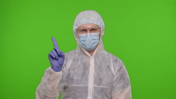 Doctor in PPE Protective Suit Disapproving Showing Warning Rejecting Dangerous No Sign on Chroma Key