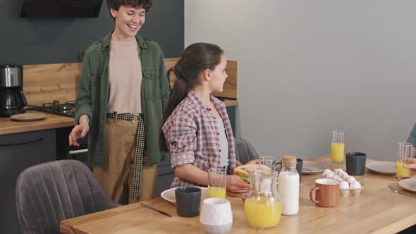 Delighted Family With Two Kids Having Breakfast