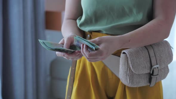 Close Up of Female Hands Counting a Large Amount of Money By Hand, a Woman Counts Cash. Concept of