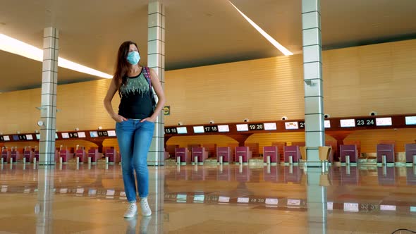 Woman Traveler in Protective Mask at Empty Airport