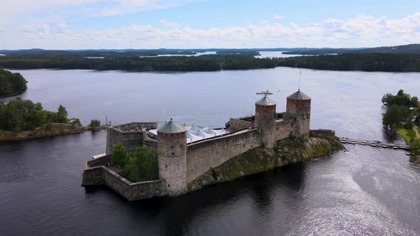 Rotating Aerial Drone Shot of Medieval Castle Olavinlinna (Finland) on a beautiful Summer Day