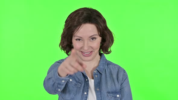 Old Woman Pointing at Camera on Green Chroma Key Background 