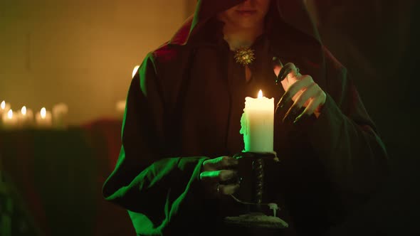 Witch Woman Holding Burning Candle Closeup