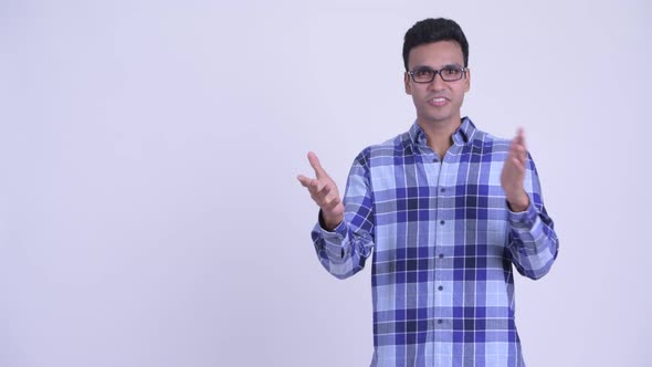 Happy Young Indian Hipster Man Presenting Something