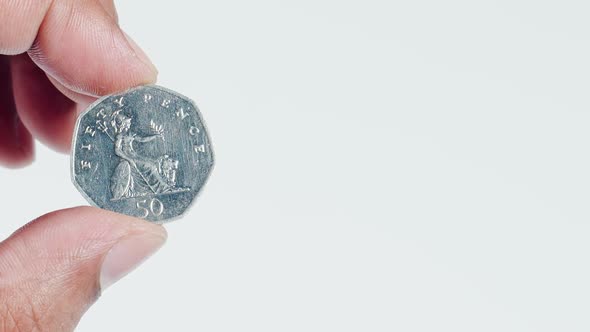 Fingers Hold A Uk 50 Pence Coin Back 