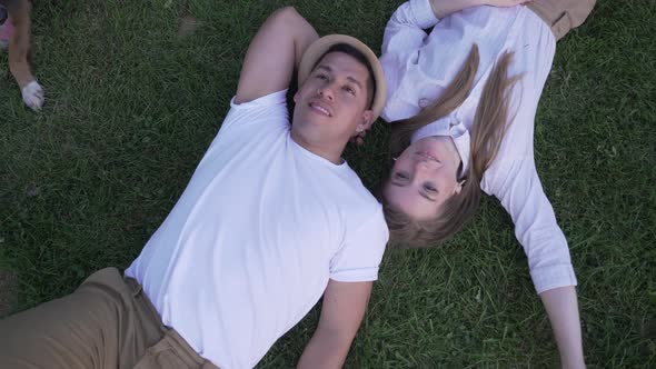 couple lying on the grass. Top view